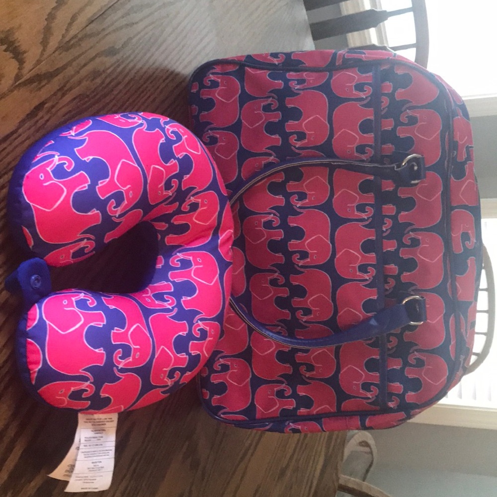 An elephant print overnight bag with neck pillow